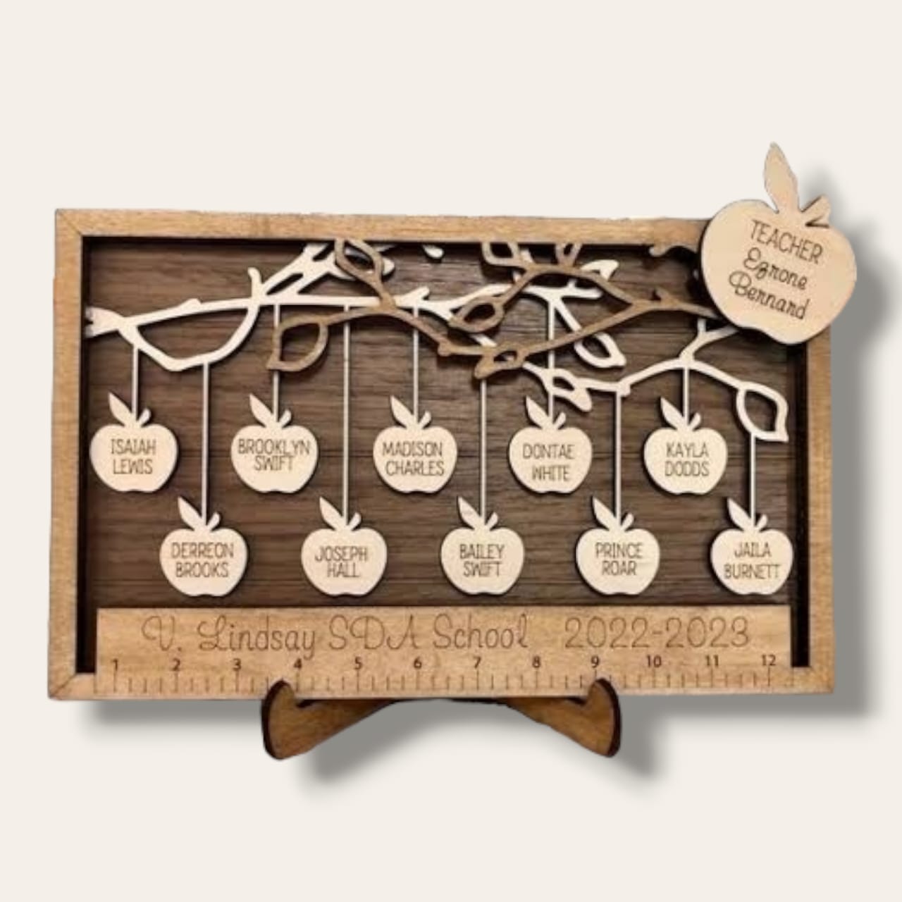 Wooden framed hanging apples from a tree stand